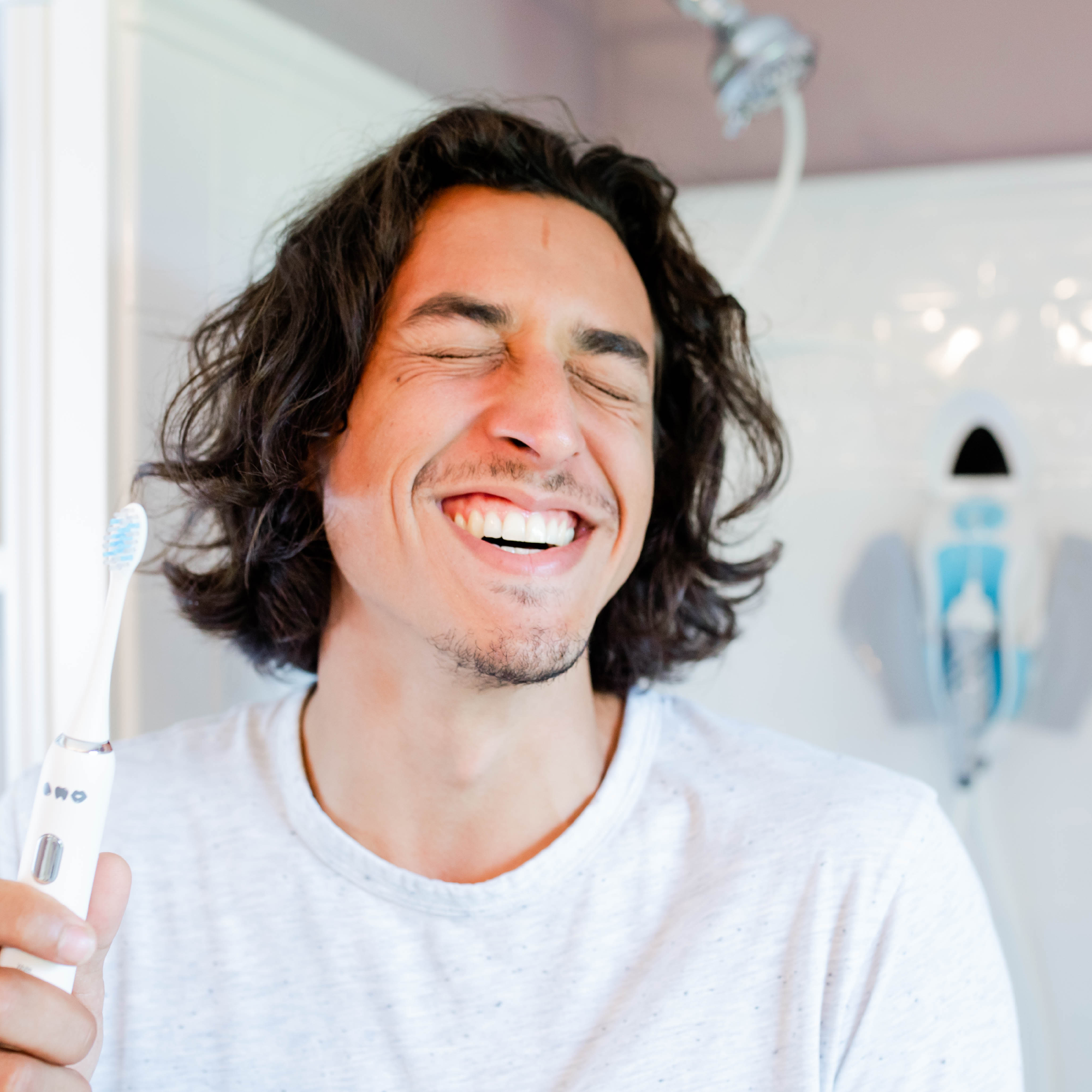 man happy his teeth are so clean with using a sonic toothbrush 